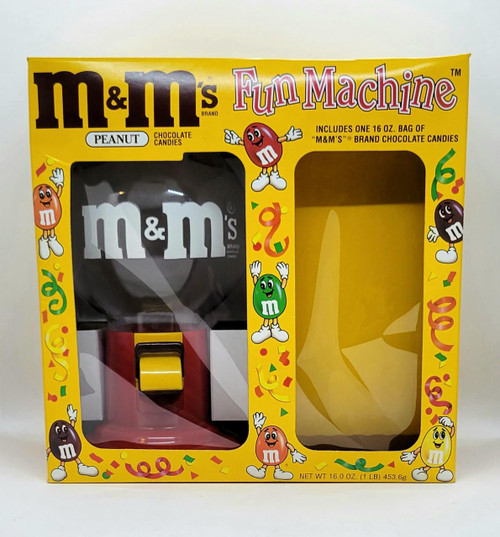 M&M's Dispenser - 1992 Fun Machine (Peanut), yellow packaging box with transparent window showcasing the black and red dispenser and colorful M&M's characters around the box.