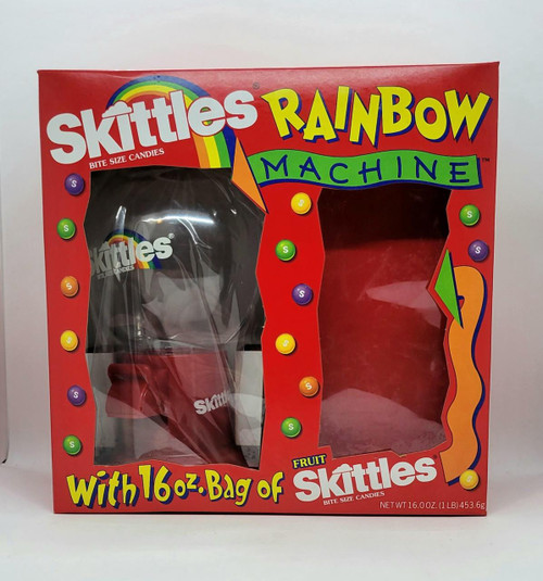 M&M Skittles Dispenser - Rainbow Machine, colorful candy dispenser box with rainbow and vibrant design, containing a clear plastic dispenser for small candies and a section for Skittles with packaging featuring bright colors and playful graphics.
