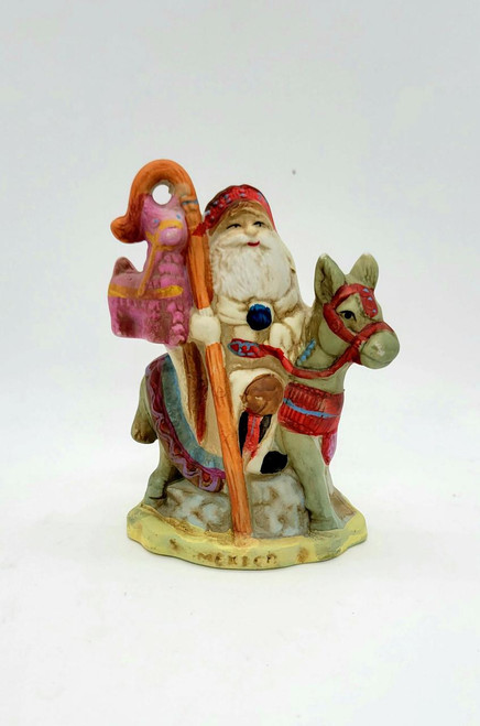 RSVP 1991 International Santa Figurine - Mexico, colorful ceramic figurine of Santa Claus riding a horse, holding a staff with a pink ornament, hand-painted details, festive Christmas decor.