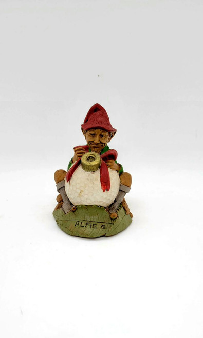 Cairn Studio, LTD Tom Clark Gnomes - Alfie (No Box) figurine featuring a gnome with a red hat, green vest, and red scarf, holding a telephone, standing on a green base with the name 'ALFIE'.