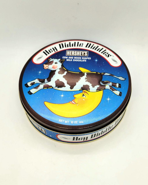 Hershey's Hey Diddle Diddles Tin, cow and moon shaped milk chocolates in a colorful round tin with a cow flying over a smiling moon.