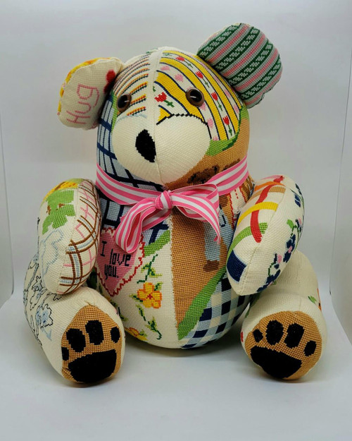 Unbranded Handmade 11 Inch Cross Stitch Teddy Bear, decorated with colorful cross stitch patterns, buttons for eyes, a pink ribbon around its neck, and embroidered paw prints.
