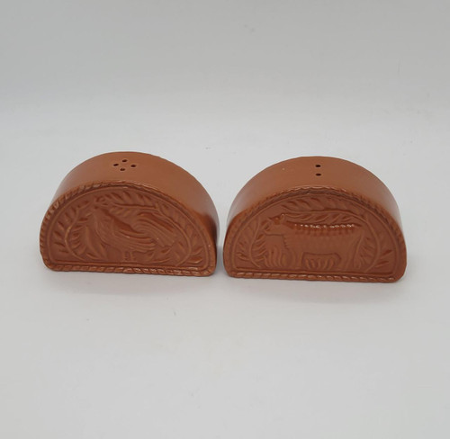 AVON Avon Terra Cotta Salt & Pepper Shakers Set, terracotta-colored ceramic salt and pepper shakers with engraved animal and leaf designs.
