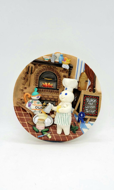 Pillsbury Doughboy Italian Zucchini Crescent Pie 3-D Collector Plate, featuring a chef doll preparing a pie in a cozy kitchen scene with a brick oven, cooking utensils, and a chalkboard that says 'Bake Off Winner Today!'
