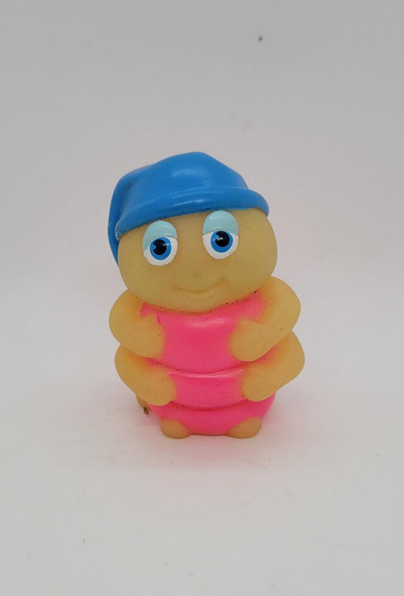 Hasbro Glo Friends Snugbug Mini Figure, small brightly colored plastic toy with a cheerful face, blue hat, and pink body.