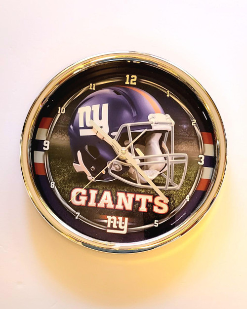 NFL New York Giants 12 inch Wall Clock, featuring a football helmet with the Giants logo and a field background.