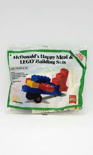 Product: Lego McDonald's Happy Meal LEGO Building Sets 4-1984 Plane, colorful LEGO brick airplane model inside clear packaging.