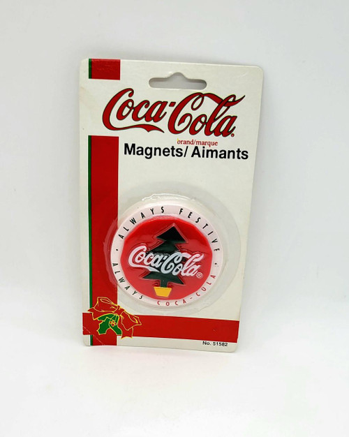 Coca-Cola Always Festive Always Coca-Cola Magnet, Christmas themed magnet with Coca-Cola logo and Christmas tree design in red, green, and yellow colors.