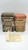 D.E. Wolfgang Candy Bavarian Village Canister #02-95 Market Square Tin, decorative collectible tins featuring detailed illustrations of Bavarian village scenes with market square and flower shop motifs.