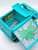 Scooby-Doo The Mystery Machine Playset, toy playset with a bright turquoise vehicle and an interior featuring tools, colorful decorations, and green slime.