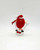 M&M Candy Topper Ornament, Red M&M Skiing figurine with a Santa hat, skis, and a ski pole, suitable as holiday cake or table decoration.