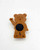 M&M's Plastic Bear Magnet, the back side of the brown bear-shaped magnet showing the magnetic surface and manufacturing details.