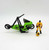 Kenner M.A.S.K. 1985 Condor Series 1 Vehicle, a green and black toy motorcycle with a futuristic design, alongside a yellow action figure in a racing suit with helmet and goggles, on a plain white background.