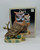 Woolworth Vintage 8-inch Fine Porcelain Owl Hand Painted Bisque Finish, detailed porcelain owl figurine with colorful facial features and textured feathers, on a decorative base with leaves, product packaging in the background.