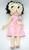 Betty Boop Easter Collection: Easter Bunny Betty Doll, plush doll with black hair, large green eyes, wearing a pink dress and holding a cartoon bunny plush, perfect for Easter celebration gifts.