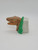 Jurassic Park Velociraptor Head Candy Dispenser, dinosaur-shaped candy dispenser with a Velociraptor head design, featuring a brown head and green foliage details on the side.