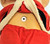 Unbranded Vintage 9-inch Santa Baby Doll, close-up of the doll's midsection showing a metallic screw in its stomach area, dressed in red fabric with a fleece-lined hoodie.