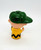 Peanuts Vintage 1950 Charlie Brown Finger Puppet, a small character figurine from the Peanuts comic strip wearing a green cap and yellow shirt with black zigzag pattern.