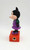 Disney 1960's Minnie Mouse Pencil Sharpener, vintage Minnie Mouse figurine with a purple dress, green sleeves, and black shoes, mounted on an orange base with a hole for inserting pencils.