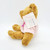 AVON 2001 Breast Cancer Awareness Teddy Bear, plush teddy bear wearing a pink shirt with a pink ribbon symbol for breast cancer awareness.