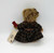 Russ Berrie & Co Russ Berrie Vintage Edition #44701 Brittany Teddy Bear, a vintage plush teddy bear dressed in a plaid coat with brown accents and a red ribbon handle.