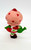 Strawberry Shortcake Strawberryland Miniatures Strawberry Shortcake With Her Watering Can, miniature figurine of Strawberry Shortcake holding a green watering can.