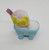 Strawberry Shortcake Strawberryland Miniatures Angel Cake Taking Bubble Bath, miniature figurine of a character taking a bubble bath in a blue tub with a white surface and yellow accents.