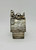 Peanuts 1958 Snoopy On Dog House Piggy Bank Silver Plated, vintage silver-colored Snoopy on a dog house piggy bank with textured wood grain surface.