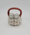Unknown Vintage Puppy Basket Fairing, ceramic figurine of a basket with two puppies shaped handles, glazed with white and brown details.