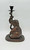 Bombay Company 10.5" tall bronze elephant candle stick holder statue. The statue is an elephant seated using his trunk to hold a stick in the air that contains the candle stick holder. Side view