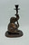 Bombay Company 10.5" tall bronze elephant candle stick holder statue. The statue is an elephant seated using his trunk to hold a stick in the air that contains the candle stick holder. Side View