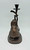 Bombay Company 10.5" tall bronze elephant candle stick holder statue. The statue is an elephant seated using his trunk to hold a stick in the air that contains the candle stick holder. Rear View