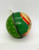 Vintage Regal Imports tin litho Santa Claus 2" candy container Christmas ball ornament. The green tin ball features a litho of Santa's face on the front. Side view