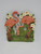 2 toggle resin wallplate with 2 pink flamingos with green grass at their feet and white flowers above them.
