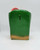 Unknown Vintage Chalkware Santa Claus Bank, green and red chalkware bank with a slot for coins on the front and a gold-colored base.