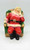 Unknown Vintage Chalkware Santa Claus Bank, vintage chalkware Santa Claus figurine sitting on a green chair, holding his face with one hand, red suit with white trim, black belt, and black boots, decorative holiday collectible.