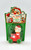 Fun World Vintage Fun World Pull Along Santa With Pop Up Squeaky Toy, holiday-themed Santa figure with a red suit and hat on a green wheeled pull toy, packaged with festive Christmas decorations on the label.