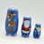 Babooshkah Rudolph The Red-Nosed Reindeer 50th Anniversary Wood Nesting Doll Set, set of three blue nesting dolls featuring Rudolph the Red-Nosed Reindeer, Santa Claus, and Hermey, decorated with festive holiday illustrations.