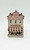 Windy Meadows Pottery Chocolateria Clay House, decorative miniature ceramic building with pink and gray colors, featuring a sign that says 'Chocolatezia,' small windows, and a striped awning.