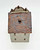 Windy Meadows Pottery Chocolateria Clay House, a detailed ceramic sculpture featuring a brick-textured roof with a small brick chimney, and a white-painted base with miniature windows for a charming, rustic appearance.