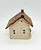 Windy Meadows Pottery Produce Store Clay House, handcrafted ceramic house with a textured brick design and a rustic, shingled roof.