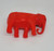 Unknown Vintage Celluloid Red Elephant Toy Figure, a small carved red plastic elephant with detailed features and a curved trunk, on a plain white background.