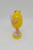 M&M's 2018 Yellow M&M Character Case Plastic Figure, collectible yellow character with arms, legs, white shoes, and a standing pose.