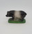Unknown Vintage Chalkware Hampshire Pig Figure, vintage chalkware pig figurine with a black and gray body standing on a green base.