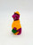 Barney and Friends 1993 Rainy Day Barney PVC Toy Figure, purple dinosaur wearing a yellow raincoat and hat, holding a green umbrella, on a plain white background.