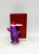 Hallmark Keepsake Ornament 1994 Barney the Dinosaur, purple dinosaur wearing a red Santa hat and blue scarf, standing beside a red box with gold base.