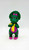 Barney and Friends Baby Bop 4.75-inch Toy Figure, colorful green dinosaur with purple and pink accents and a yellow tie, with a cheerful expression and large eyes.