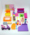 Polly Pocket Lot of Furniture, Scooter and Clothes, a collection of pink, purple, orange, and green miniature furniture and accessories for dolls, including a scooter, beds, sofas, clothing, and playset items.