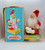 Vintage musical Santa figure sitting on present Made in Japan.  Wind up Santa and watch him rotate slowly to the sounds of Jingle Bells.  Santa has a grumpy look while sitting on a gold wrapped present.