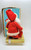 Vintage musical Santa figure sitting on present Made in Japan.  Wind up Santa and watch him rotate slowly to the sounds of Jingle Bells.  Santa has a grumpy look while sitting on a gold wrapped present.